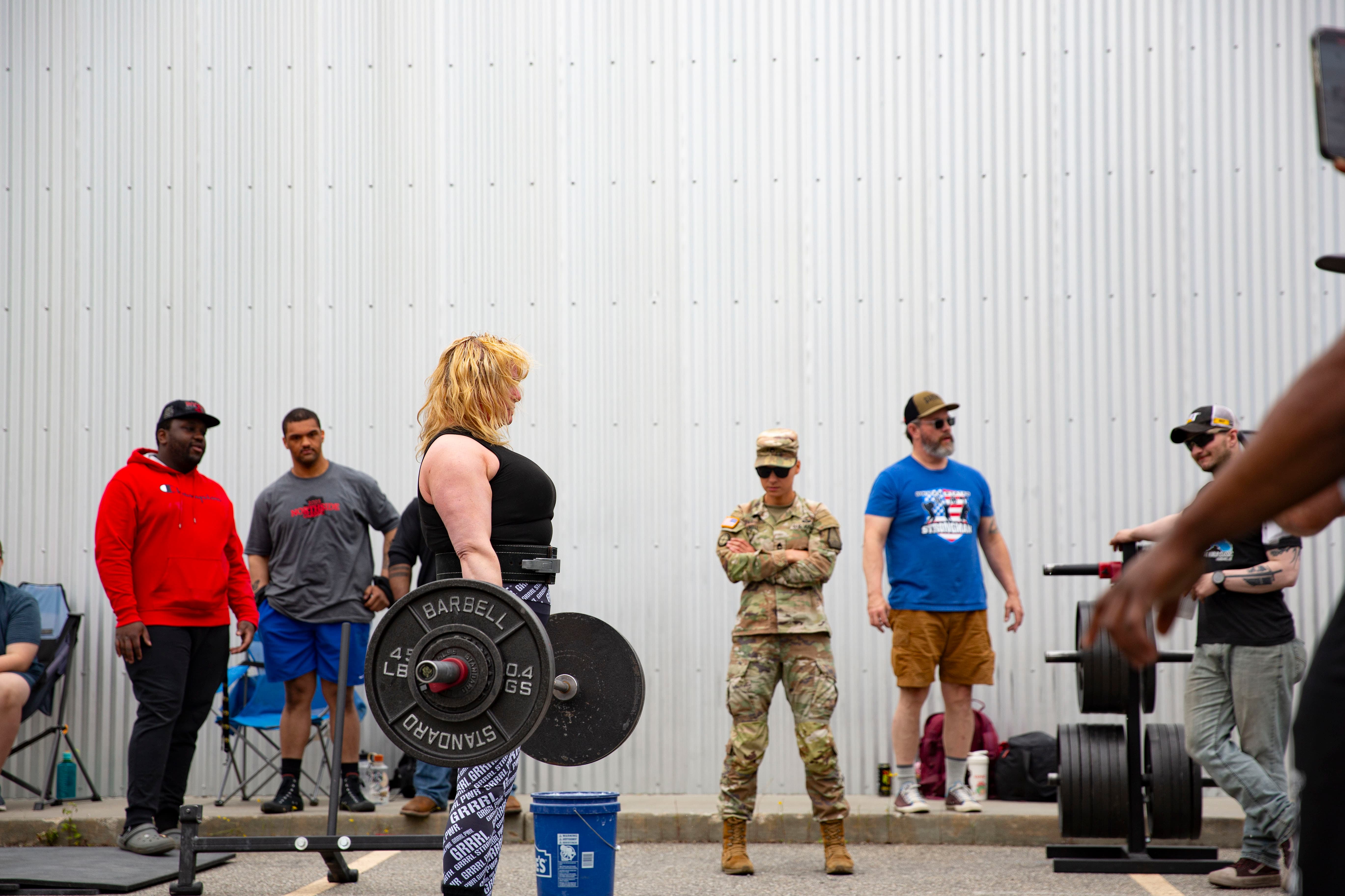 Northside Athletics — field event competitor with coaches watching from the sideline