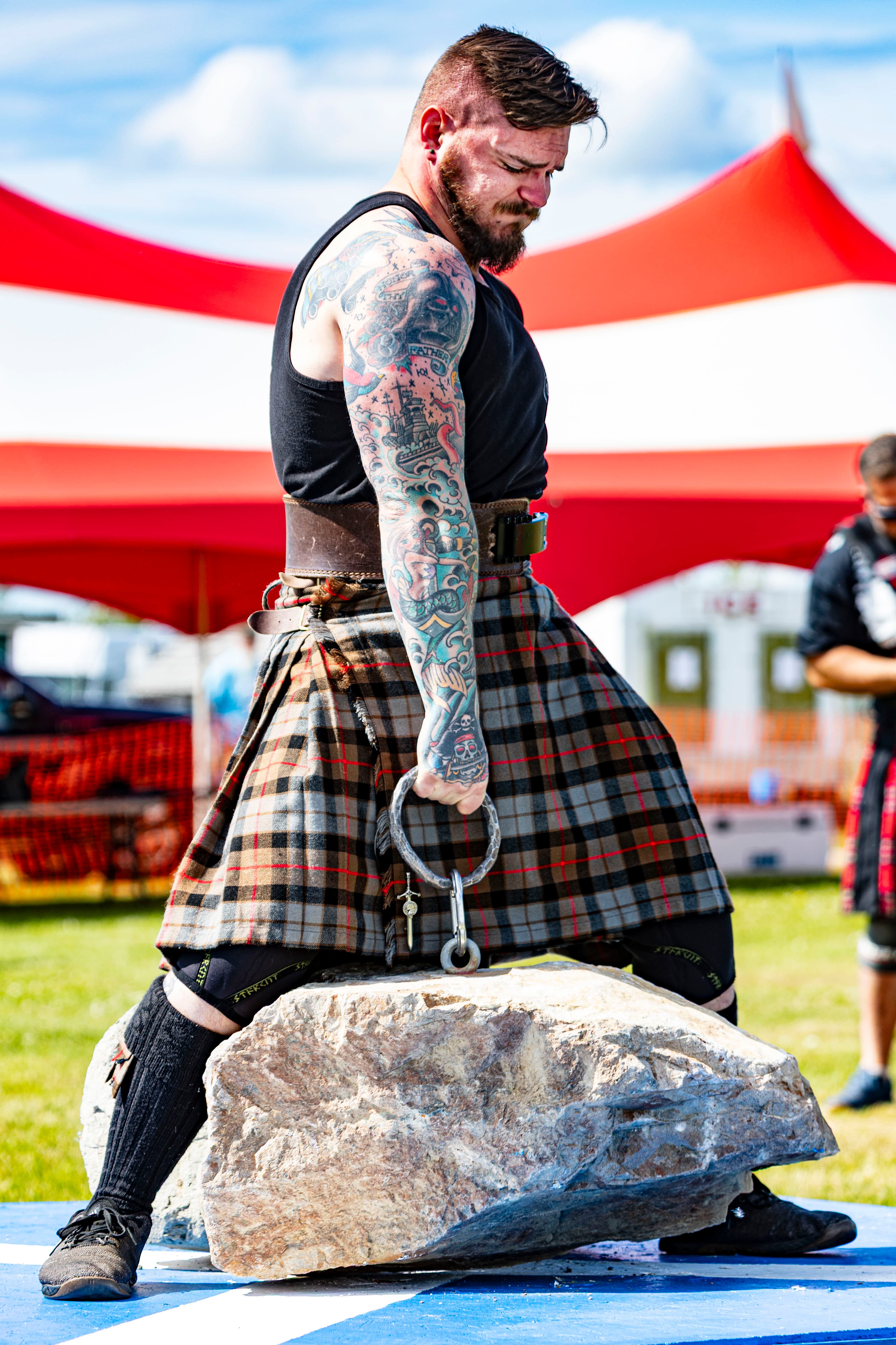 Denali Stones strongman competition — athlete lifting a heavy stone overhead