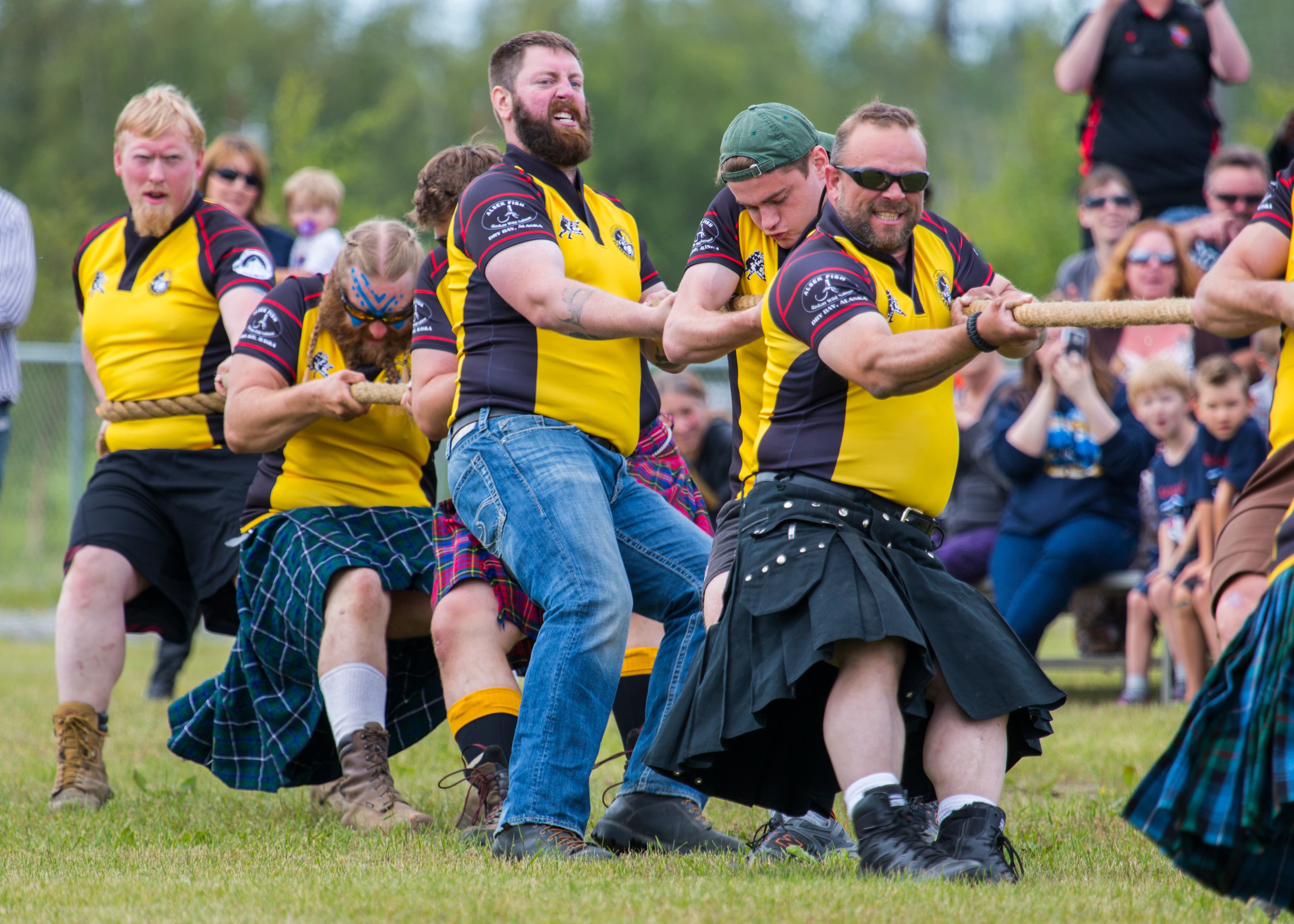 Highland Games athlete preparing for a strength event, muscle and concentration on display